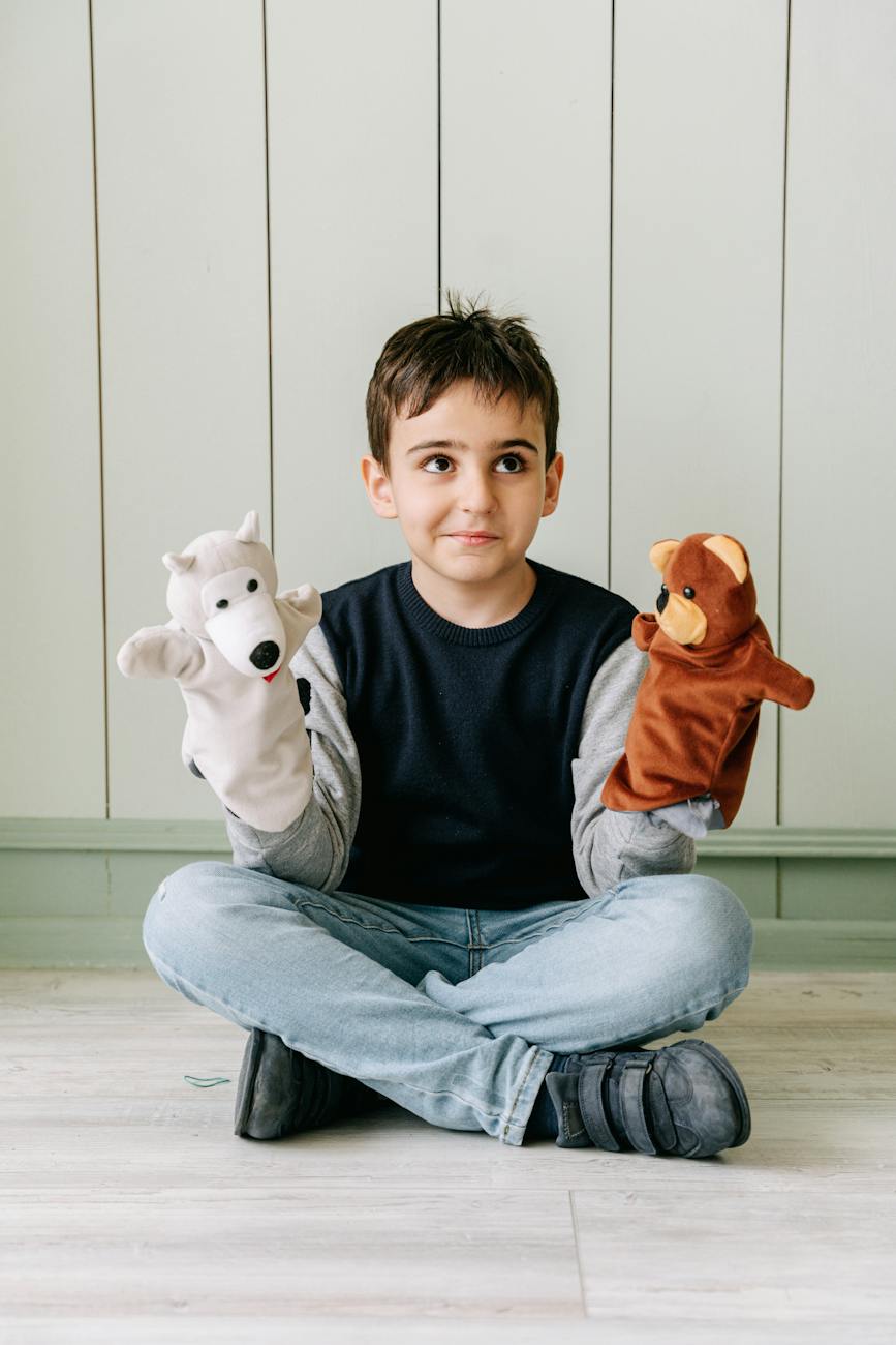 a boy playing with puppets